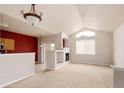 Open living area with vaulted ceilings, a cozy fireplace, and lots of natural light at 22675 E Ontario Dr # 202, Aurora, CO 80016