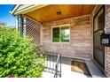 Inviting front porch featuring a brick accent wall, decorative latticework, and a 'Welcome' mat at 2268 Jay St, Edgewater, CO 80214