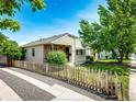 Charming home with a manicured front yard, complemented by a picket fence and mature trees at 2268 Jay St, Edgewater, CO 80214