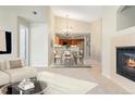 Open-concept space with fireplace, dining area with chandelier, and a view of the kitchen at 8623 E Dry Creek Rd # 423, Englewood, CO 80112