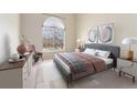 Primary bedroom with large window, modern decor, accent furniture and stylish artwork at 8623 E Dry Creek Rd # 423, Englewood, CO 80112
