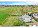 Aerial view of home's extensive fenced backyard, including lawn, firepit, and potential for outdoor living at 215 Jay St, Lakewood, CO 80226