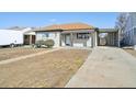 Charming exterior of the home with a covered area for parking and well-maintained yard at 3340 Leyden St, Denver, CO 80207