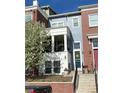 Charming townhome boasts a welcoming porch, well-maintained landscaping, and appealing curb appeal during spring at 3401 N Xenia St, Denver, CO 80238