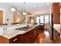 Modern kitchen featuring granite countertops, stainless steel appliances, and a gas cooktop at 3401 N Xenia St, Denver, CO 80238