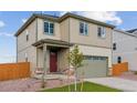 Charming two-story home with a two-car garage, complemented by a well-maintained lawn at 17969 Dandy Brush Ln, Parker, CO 80134