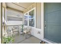Inviting covered front porch with seating area, perfect for relaxing and enjoying the outdoors at 27857 E 8Th Ave, Aurora, CO 80018