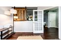 Bright living room featuring hardwood floors, modern lighting, and stylish barn door at 22026 Hill Gail Way, Parker, CO 80138