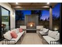 Inviting outdoor space with fireplace, comfortable seating and lighting for relaxation at 1291 S Gaylord St, Denver, CO 80210