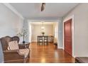 Spacious living room with hardwood floors flowing into the dining area, featuring a red entry door at 2033 S Ogden St, Denver, CO 80210