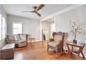 Open-concept living room showcasing hardwood floors, stylish furniture, and ample natural light at 2033 S Ogden St, Denver, CO 80210