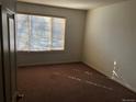 Empty bedroom with carpet, window with blinds, and natural light at 9913 E Carolina Cir # 203, Denver, CO 80247