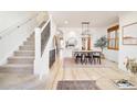 Bright dining room with wood floors, modern lighting, and staircase at 449 N Pearl St, Denver, CO 80203