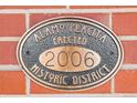 Alamo Placita Historic District plaque on the brick exterior at 449 N Pearl St, Denver, CO 80203