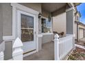 Close-up of the home's inviting front porch with white picket fence and decorative wreath at 3869 S Himalaya Way, Aurora, CO 80013