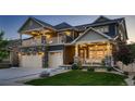 Beautiful two-story home with a well-manicured lawn and a welcoming covered front porch at 4965 Malaya St, Denver, CO 80249