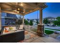 Relaxing covered porch with comfortable seating and a view of the neighborhood at 4965 Malaya St, Denver, CO 80249