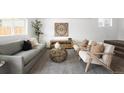 A cozy living room featuring neutral walls, modern furniture, and an attractive area rug, creating a warm, inviting space at 461 S Lowell Blvd, Denver, CO 80219