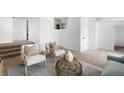 Bright living space features two chairs, light walls, and a decorative vase on a table, with a doorway on the right at 461 S Lowell Blvd, Denver, CO 80219