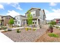Attractive home featuring manicured landscaping and a cozy front porch at 8057 Monte Vista Cir, Littleton, CO 80125