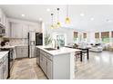 Modern kitchen with stainless steel appliances, a center island, and an open layout at 8057 Monte Vista Cir, Littleton, CO 80125