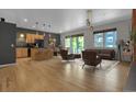 Open concept living room with kitchen, dining area, and modern furniture at 1438 Little Raven St # 201, Denver, CO 80202