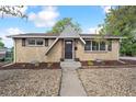 Charming brick home featuring a unique triangular roof design and well-maintained landscaping at 6953 Elati Way, Denver, CO 80221
