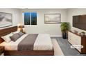 Cozy bedroom featuring a queen-sized bed, large window, and contemporary decor at 5480 W 74Th Ave, Arvada, CO 80003