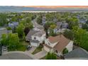Desirable neighborhood showcases well-maintained homes, mature trees, and scenic mountain views in the distance at 3087 Deer Creek Trl, Highlands Ranch, CO 80129