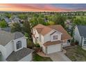 Expansive two-story home boasts a spacious layout, two-car garage, and lovely sunset views at 3087 Deer Creek Trl, Highlands Ranch, CO 80129
