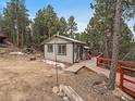 Exterior view of a charming mountain home with a spacious wooden deck at 26349 Pleasant Park Rd, Conifer, CO 80433