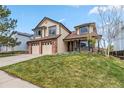 Charming two-story home with a well-manicured lawn and a two-car garage at 12551 W 84Th Cir, Arvada, CO 80005