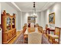 Formal dining room featuring hardwood floors, a large wooden table, decorative lighting, and classic decor at 100 S University Blvd # 4, Denver, CO 80209
