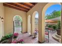 Inviting outdoor patio with arched openings, tile flooring, and comfortable seating area at 100 S University Blvd # 4, Denver, CO 80209