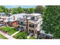 Aerial view of a modern home with multiple balconies and landscaped yard in a residential neighborhood at 1426 S Pearl St, Denver, CO 80210