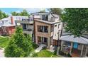 Modern home featuring multiple balconies, landscaped yard, and unique architectural details at 1426 S Pearl St, Denver, CO 80210