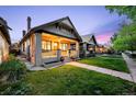 Quaint home showing the front exterior, a charming porch, and a lush green lawn during twilight at 1469 S Lincoln St, Denver, CO 80210
