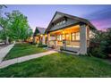 Charming neighborhood home with a cozy porch, colorful flower pots, and a well-kept green lawn at 1469 S Lincoln St, Denver, CO 80210