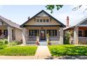 Inviting craftsman-style home with a welcoming front porch, beautiful lawn, and a classic facade at 1469 S Lincoln St, Denver, CO 80210
