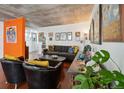 Living room with gray sofa and unique wall art at 2 Adams St # 1010, Denver, CO 80206