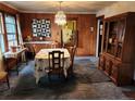 Classic dining room with vintage chandelier, decorative furnishings, and adjacent kitchen view at 3036 W Clyde Pl, Denver, CO 80211