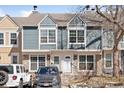 Two-story townhome featuring stone accents, light blue siding, and a white door at 1260 S Idalia St, Aurora, CO 80017