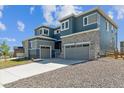 Attractive new home displaying stone accents, a gray two-car garage, and a concrete driveway at 1784 Morgan Dr, Erie, CO 80516
