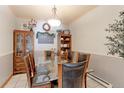 Elegant dining room featuring a glass-top table, leather chairs, and decorative wall accents at 409 N Garden Ct, Platteville, CO 80651