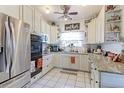 Well-lit kitchen with white cabinets, granite countertops, stainless steel appliances, and decorative accents at 409 N Garden Ct, Platteville, CO 80651