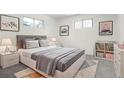 Cozy bedroom with modern decor, plush carpet, and natural light from two windows at 3081 Zion St, Aurora, CO 80011