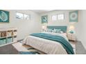 Charming bedroom with a plush bed, modern decor, and playful storage solutions for a cozy and inviting space at 3081 Zion St, Aurora, CO 80011