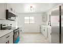 Modern kitchen with white cabinets, stainless steel appliances, and bright natural light at 3081 Zion St, Aurora, CO 80011