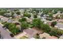 Aerial view of a home surrounded by trees, residential neighborhood, and a green backyard at 5167 Sable St, Denver, CO 80239