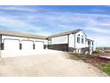 Charming two-story home with an attached three-car garage and a wide driveway for ample parking at 18553 County Road 5, Berthoud, CO 80513
